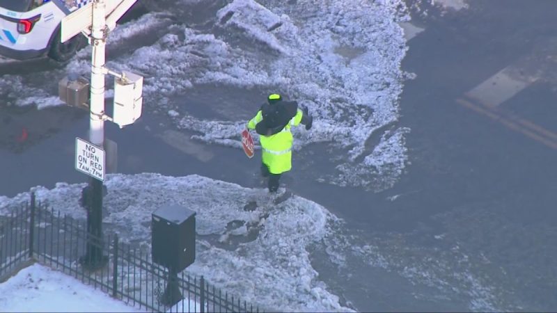 video:-crossing-guard-carries-child-across-flooded-chicago-street