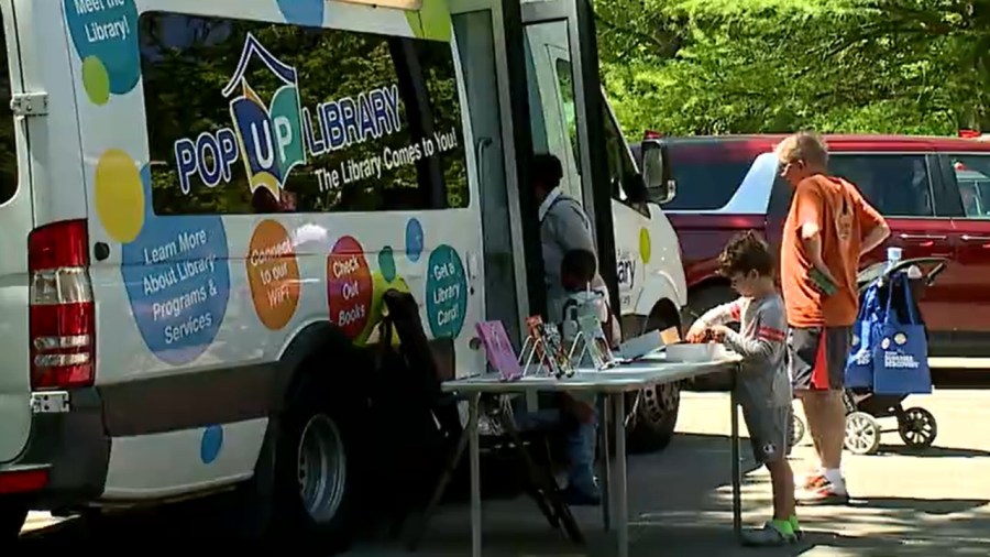 pop-up-library-sets-up-in-the-park-to-sign-up-kids-for-summer-discovery-program
