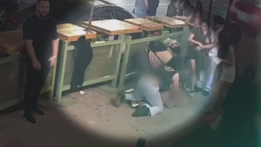 watch:-woman-attacks-young-girl-selling-flowers-outside-bar-at-closing-time